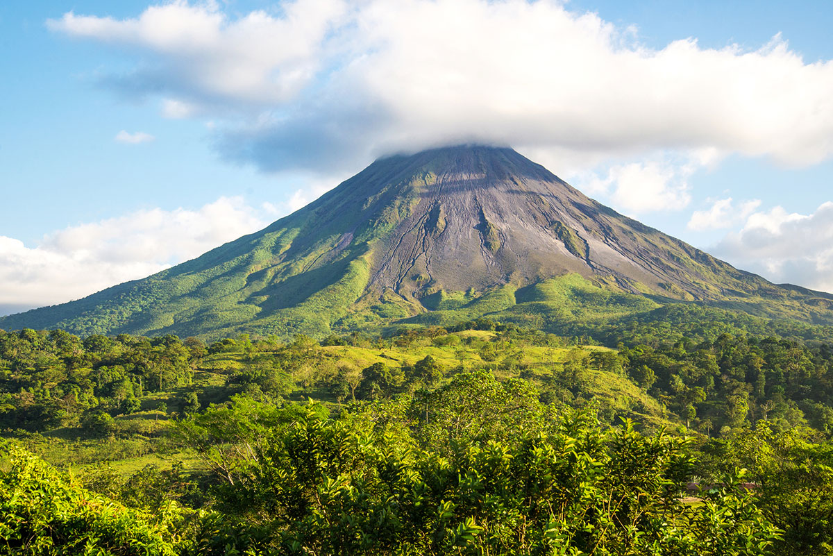 Steam and clouds hover over Arenal Volcano.