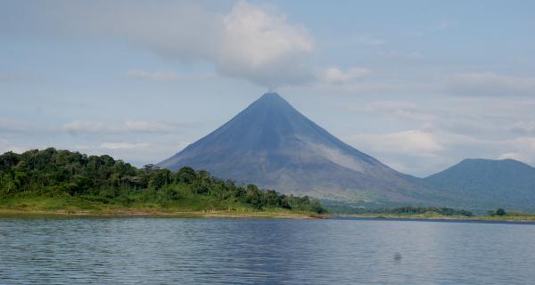 Arenal Volcano Tour Image: Across from Lake Arenal sits a forest and Arenal Volcano.