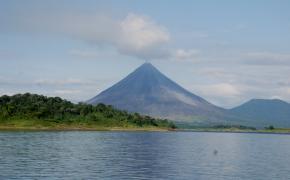 Arenal Volcano Tour Image: Across from Lake Arenal sits a forest and Arenal Volcano.